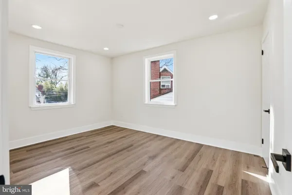 a view of a room with wooden floor and window