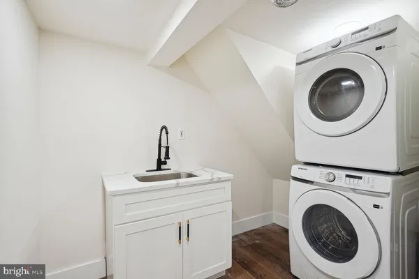 a close view of a utility room with dryer and washer