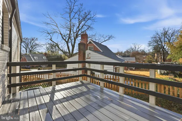 a view of a balcony with wooden floor and fence