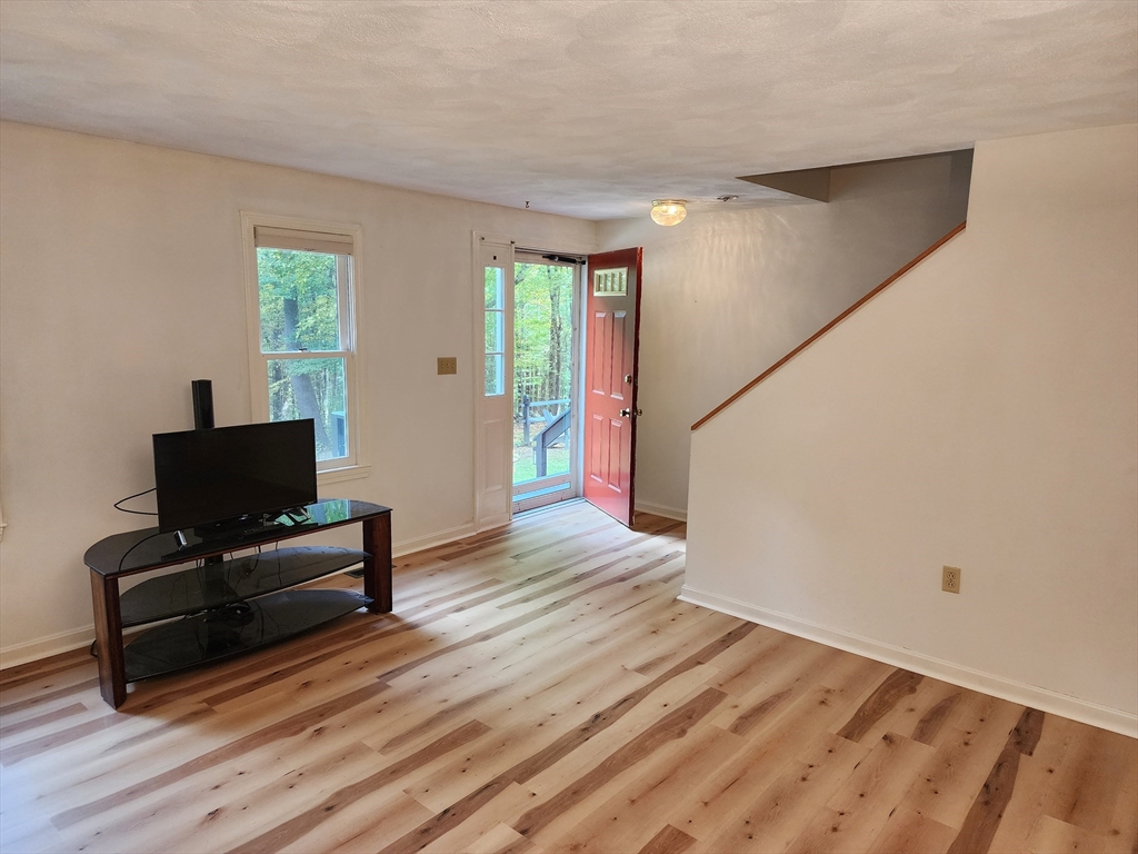 44 Lawton Road, Unit B Shirley, MA 01464 - Photo 10 of 29 a view of a livingroom with wooden floor and furniture
