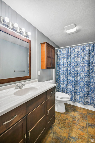 10 North Main Street Centerfield, UT 84622 - Photo 27 of 52 Full bath featuring vanity, a textured ceiling, and shower / tub combo