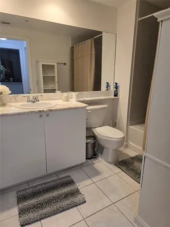 a bathroom with a sink toilet and mirror