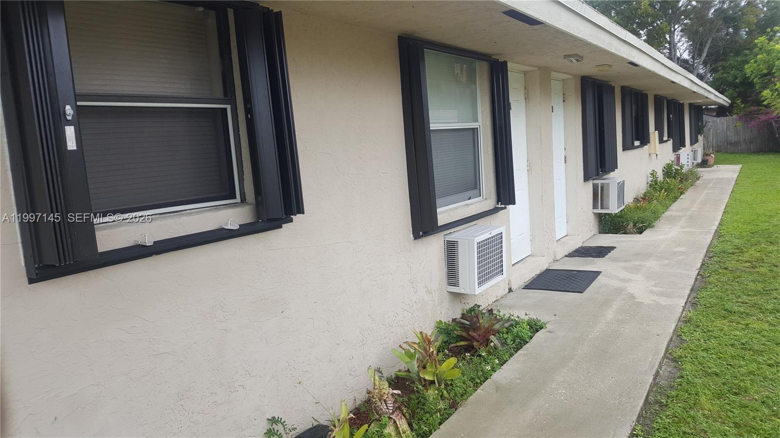 237 Southwest 5th Street Deerfield Beach, FL 33441 - Photo 2 of 11 a view of a house with a yard