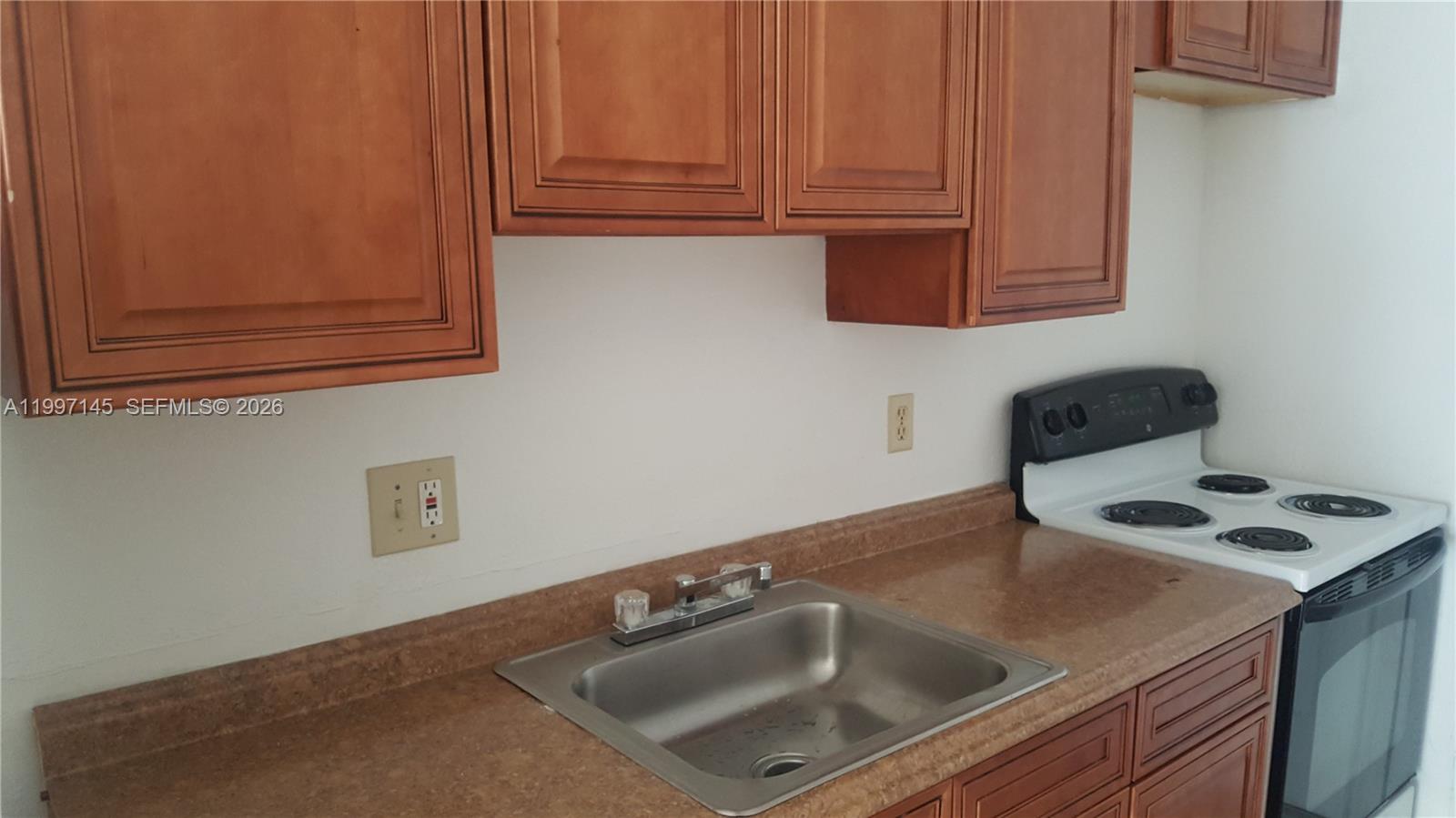 237 Southwest 5th Street Deerfield Beach, FL 33441 - Photo 4 of 11 a kitchen with a sink cabinets and utility