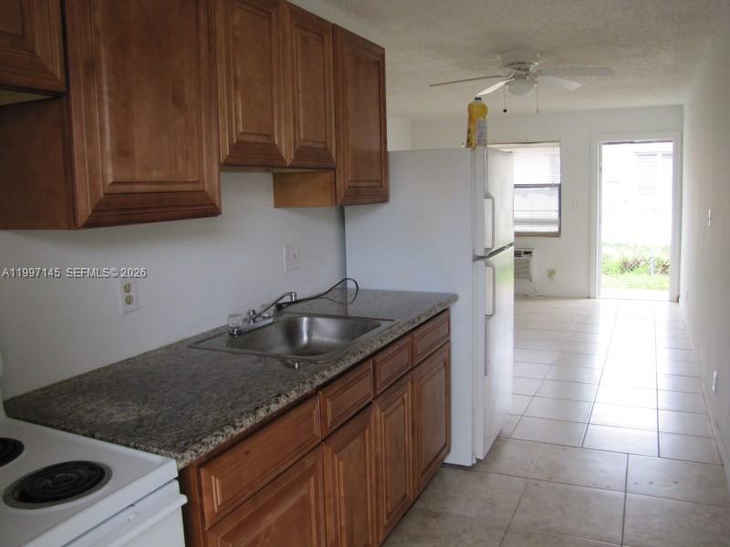 237 Southwest 5th Street Deerfield Beach, FL 33441 - Photo 6 of 11 a kitchen with a sink a stove and cabinets