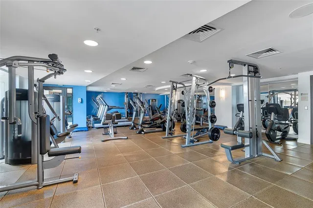 a bedroom with a large bed and a flat screen tv