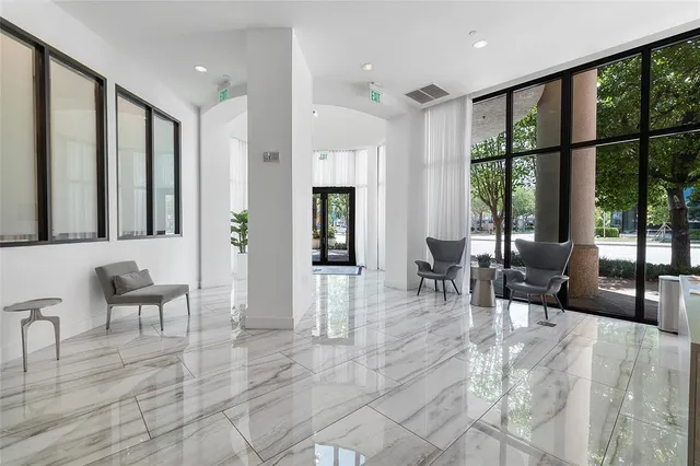 a kitchen with stainless steel appliances granite countertop a sink a stove and white cabinets with wooden floor