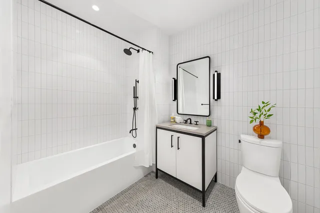 a bathroom with a toilet sink and shower