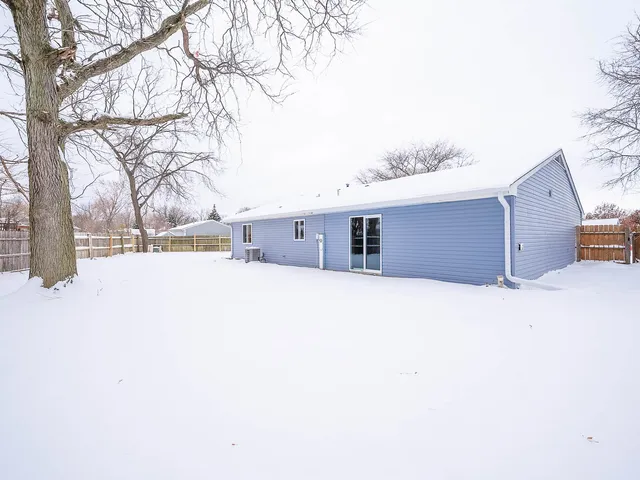 a view of a house with a snow in the yard