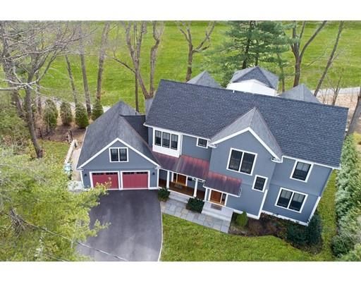 a aerial view of a house next to a yard