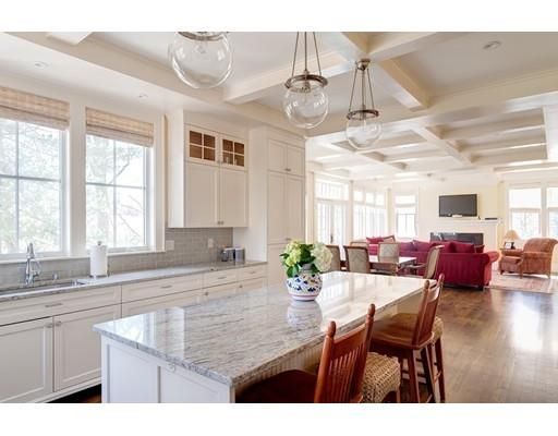 a view of a dining room and livingroom with furniture wooden floor a chandelier