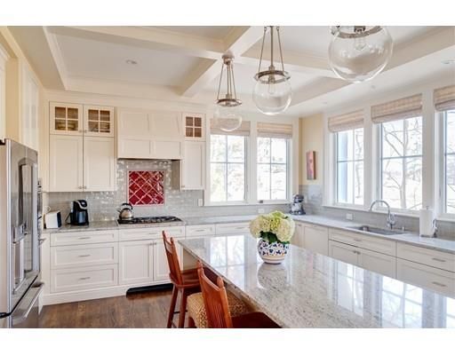 a kitchen with stainless steel appliances kitchen island granite countertop a sink and cabinets