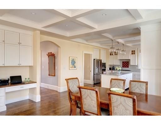 a living room with stainless steel appliances furniture and a kitchen view