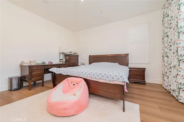 a bedroom with furniture and a wooden floor