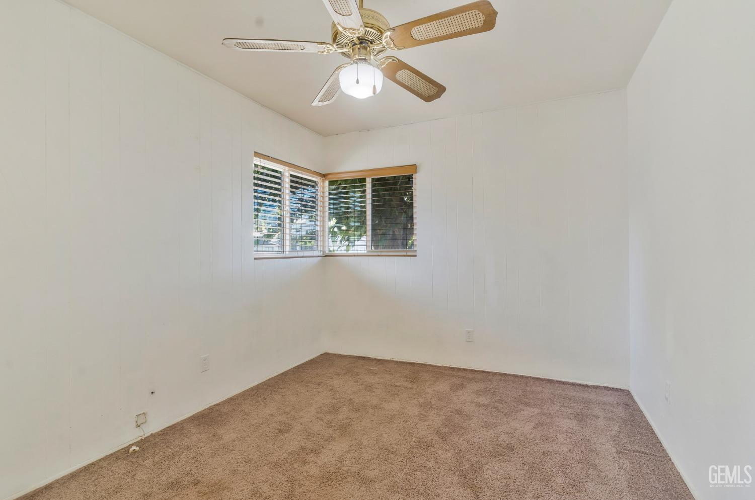 Undisclosed Address Bakersfield, CA 93304 - Photo 15 of 21 an empty room with a window and a fan