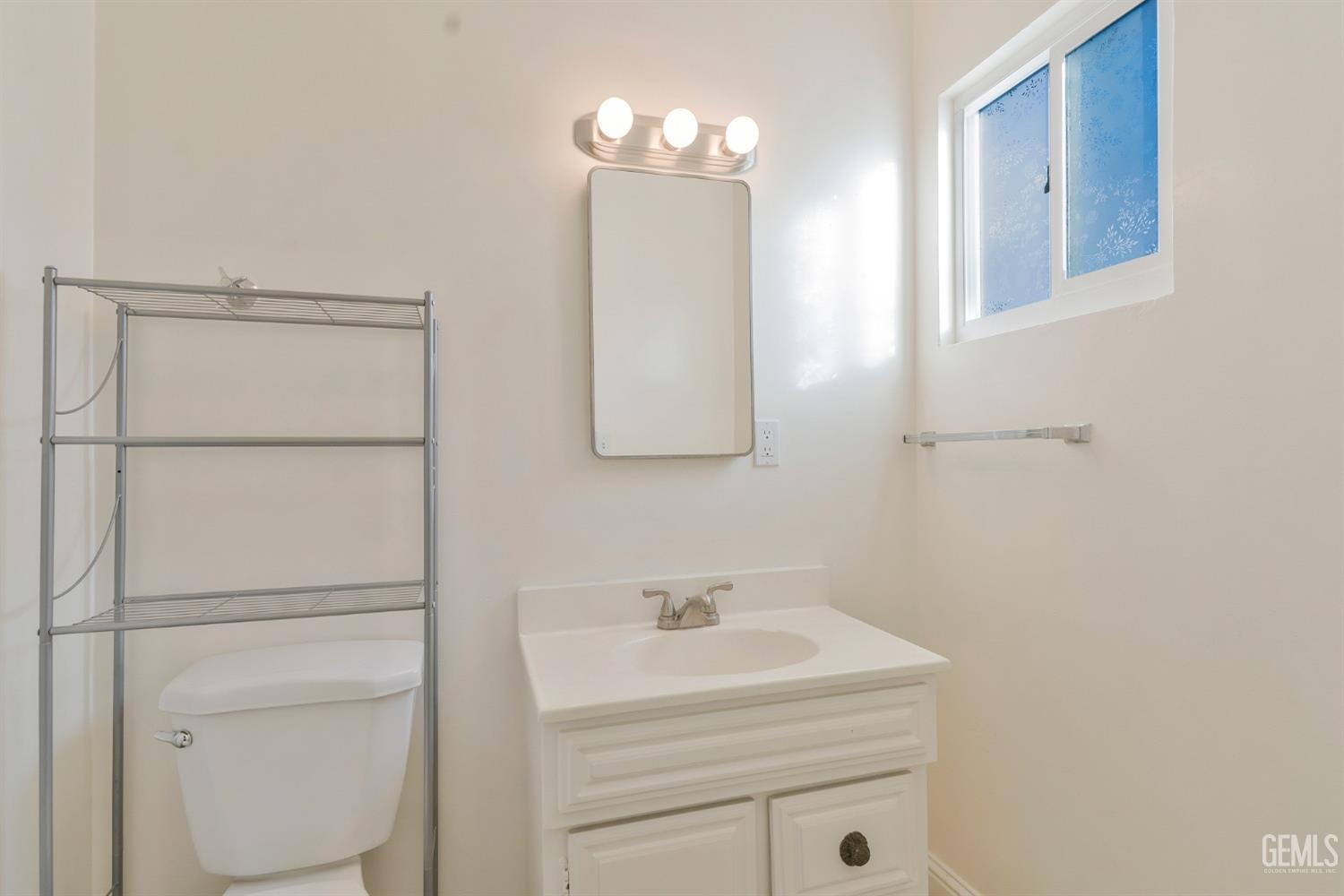 Undisclosed Address Bakersfield, CA 93304 - Photo 17 of 21 a bathroom with a sink toilet vanity and mirror