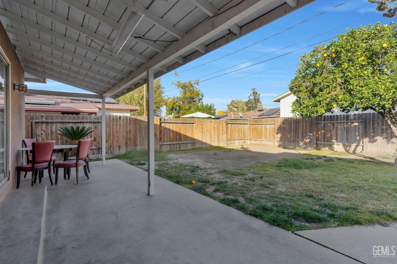 Undisclosed Address Bakersfield, CA 93304 - Photo 19 of 21 a view of a chairs and table in patio with a yard