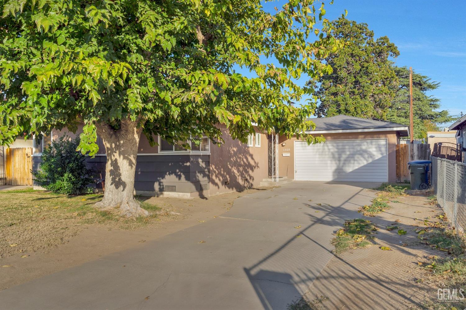 Undisclosed Address Bakersfield, CA 93304 - Photo 2 of 21 a house with trees in front of it