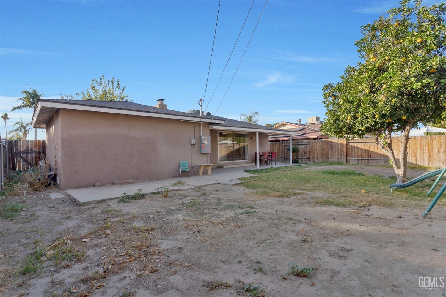 Undisclosed Address Bakersfield, CA 93304 - Photo 21 of 21 a view of a house with a yard and a tree