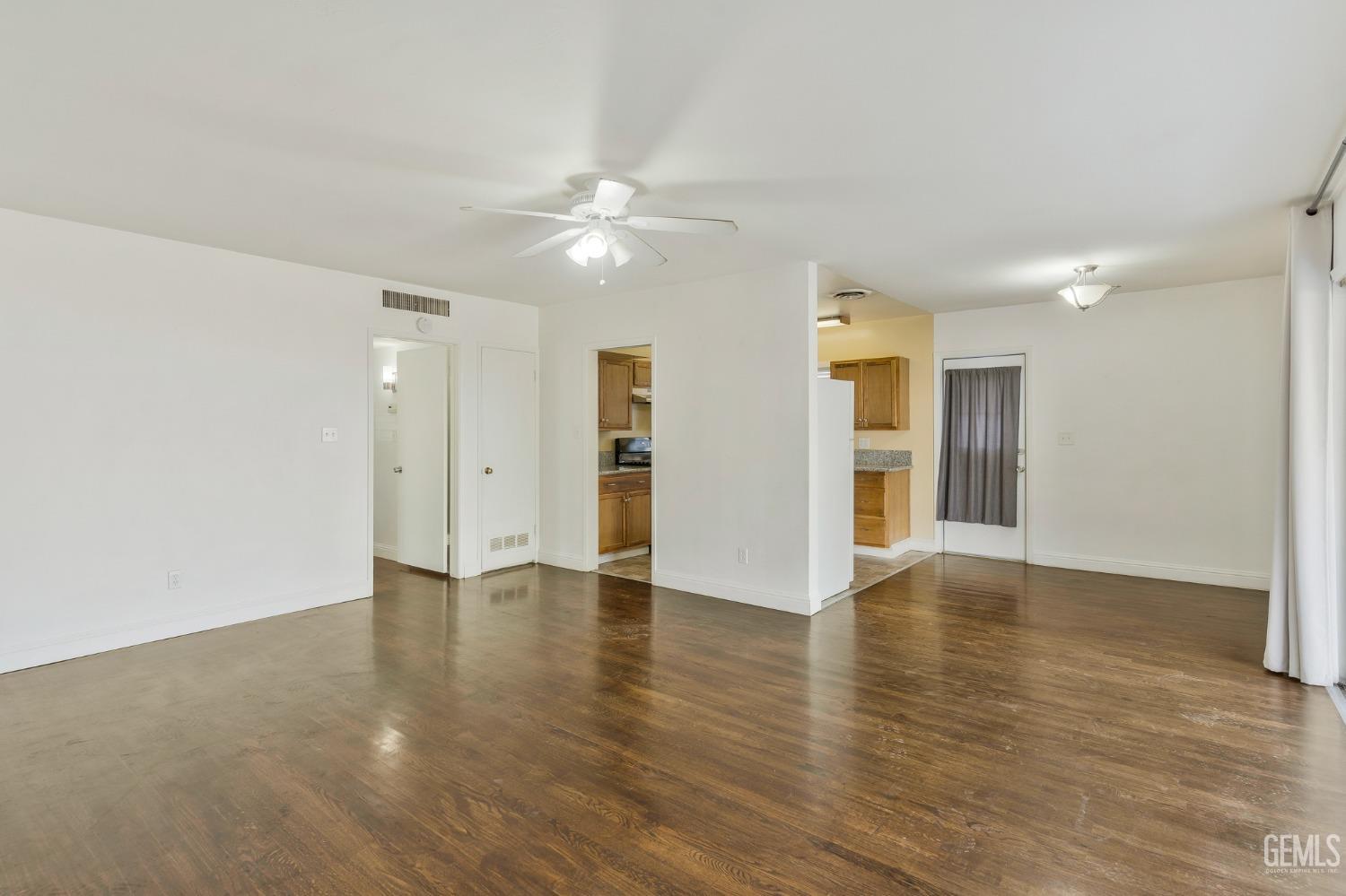 Undisclosed Address Bakersfield, CA 93304 - Photo 4 of 21 wooden floor in an empty room with a window
