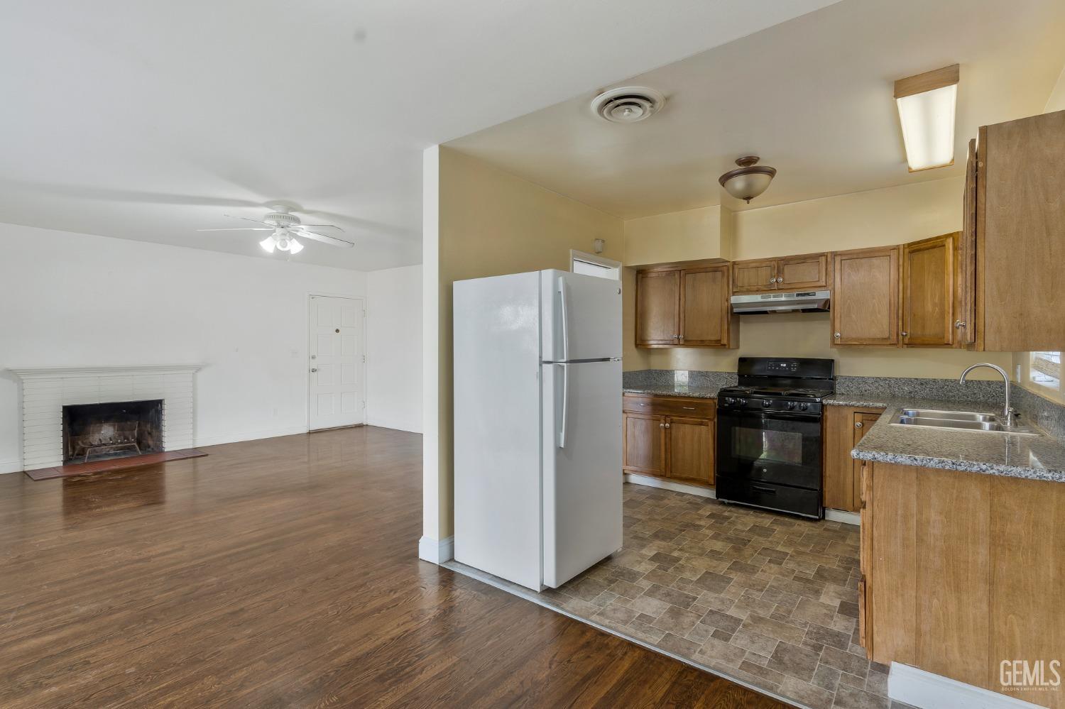 Undisclosed Address Bakersfield, CA 93304 - Photo 8 of 21 a kitchen with a refrigerator and a stove
