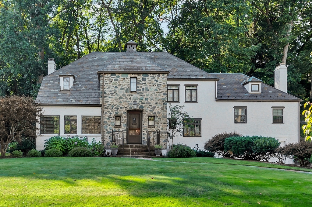 127 Gordon Road Newton, MA 02468 - Photo 1 of 24 a front view of a house with a garden