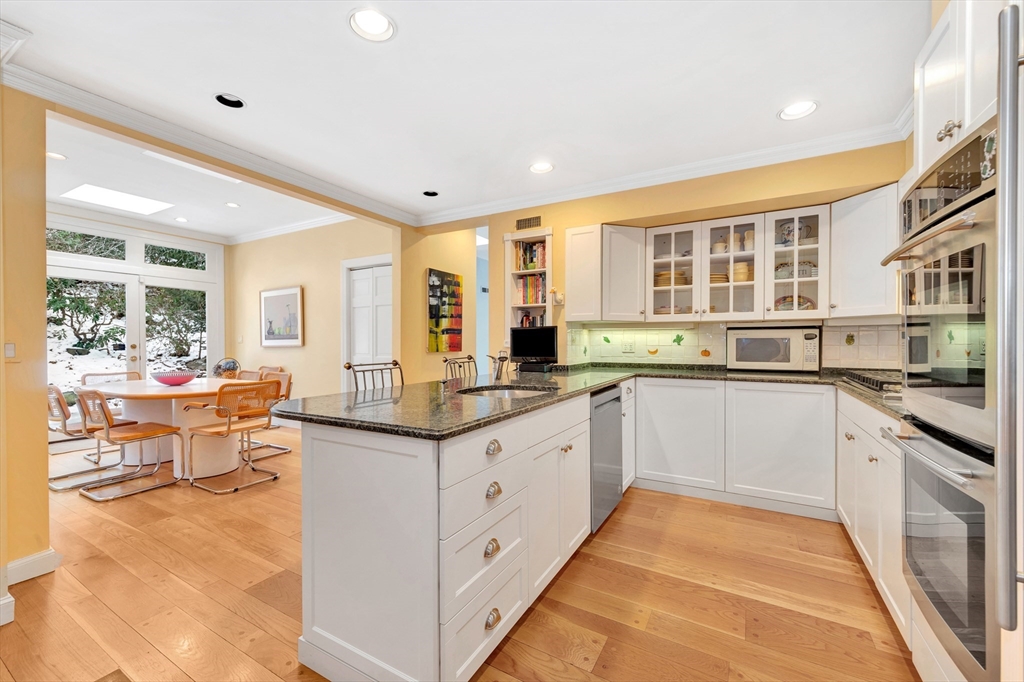 127 Gordon Road Newton, MA 02468 - Photo 11 of 24 a kitchen with stainless steel appliances granite countertop a stove and more cabinets