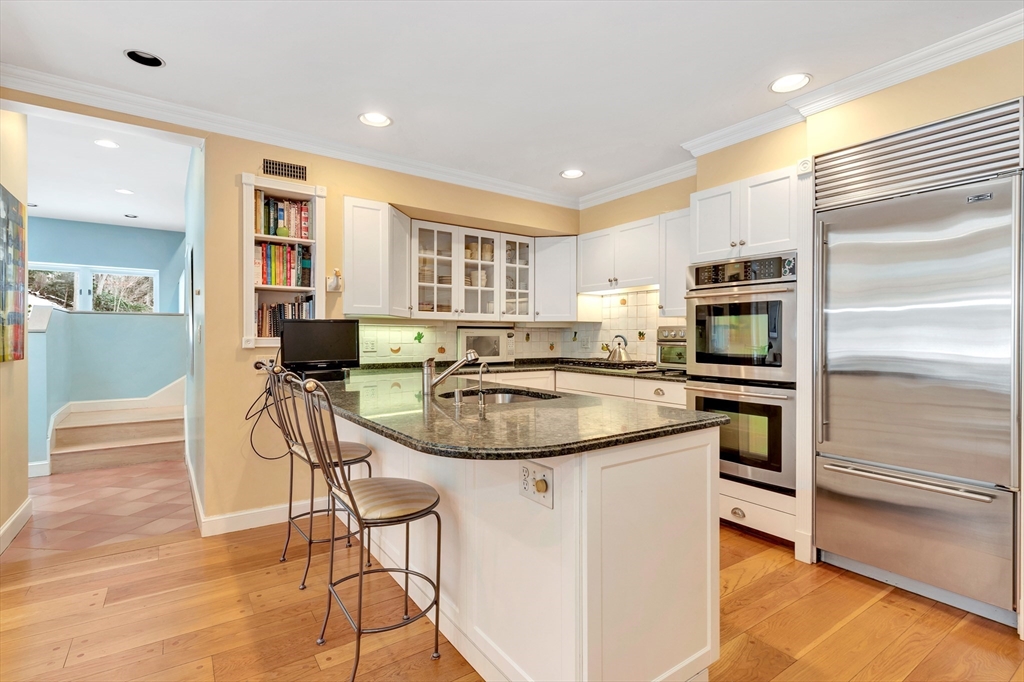 127 Gordon Road Newton, MA 02468 - Photo 12 of 24 a kitchen with stainless steel appliances granite countertop a stove and a refrigerator