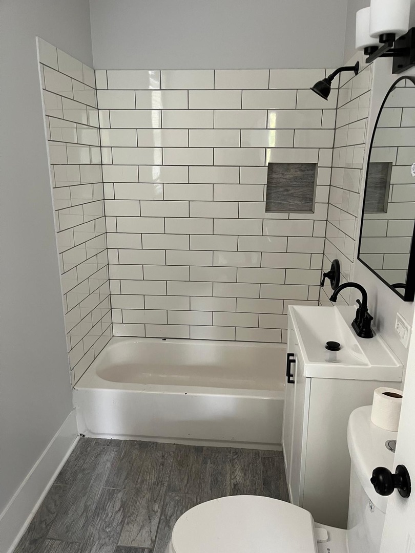 11578 South Perry Avenue Chicago, IL 60628 - Photo 11 of 11 a bathroom with a sink a toilet and shower