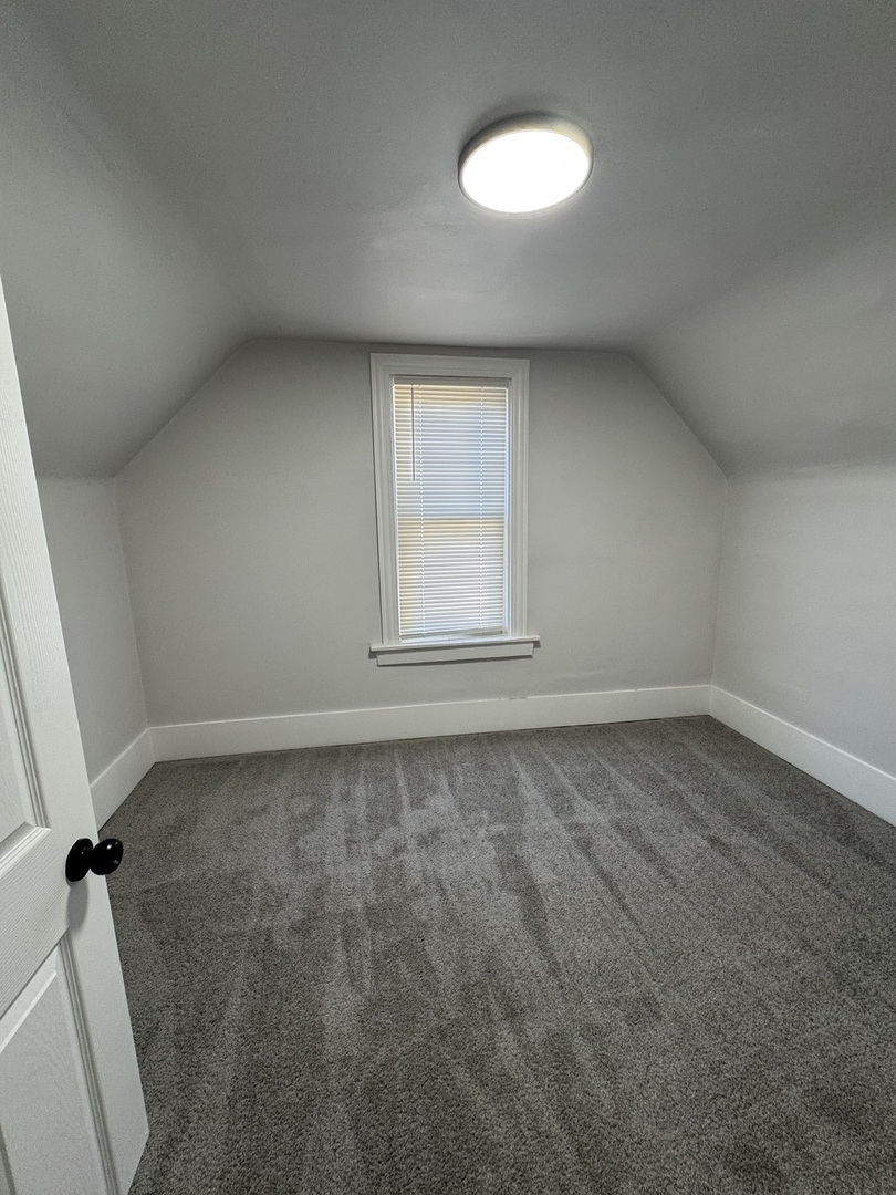 11578 South Perry Avenue Chicago, IL 60628 - Photo 9 of 11 an empty room with a empty space and a window