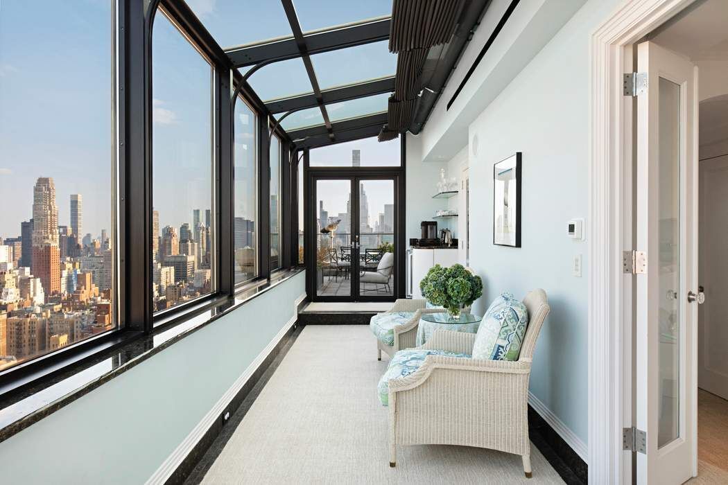 35 East 76th Street, Unit PH3407 Manhattan, NY 10021 - Photo 19 of 23 a living room with furniture and a large window