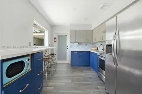 a kitchen with a stove a sink and a refrigerator