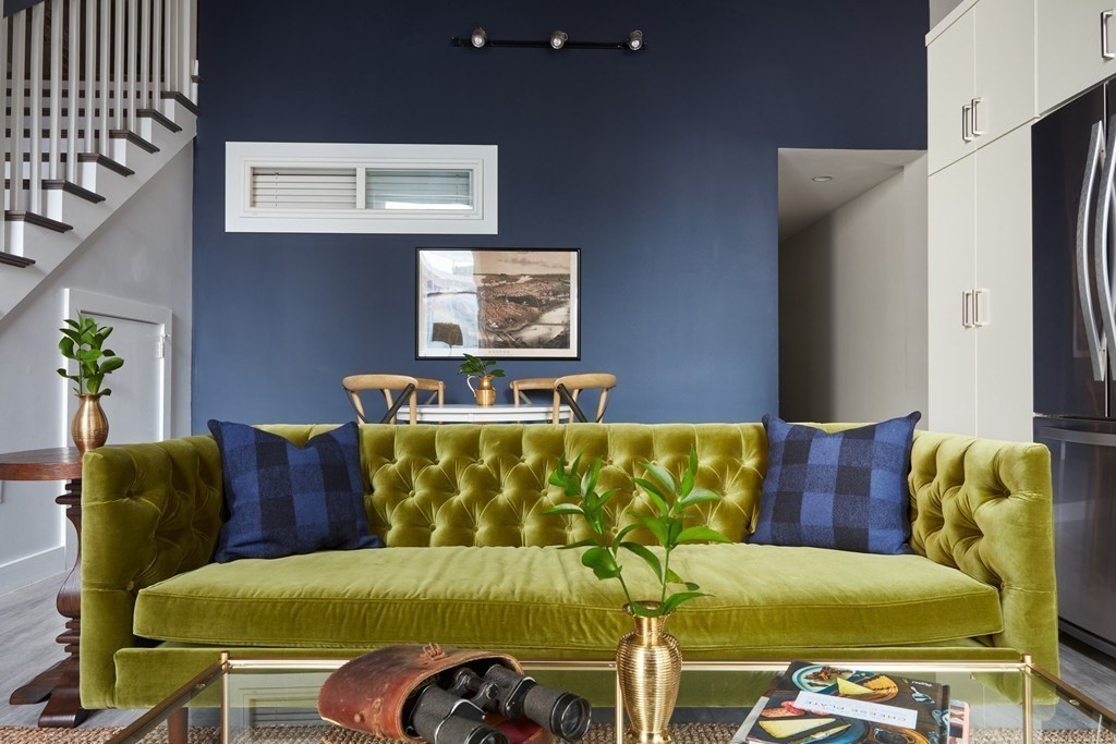 630 Washington Street, Unit 405 Boston, MA 02111 - Photo 2 of 10 a blue couch sitting next to a blue wall