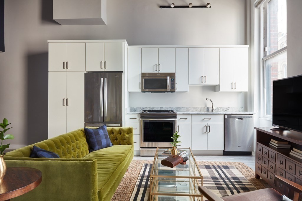 630 Washington Street, Unit 405 Boston, MA 02111 - Photo 3 of 10 a living room with furniture and a flat screen tv