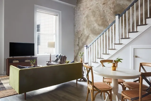 a living room with fireplace furniture and a flat screen tv