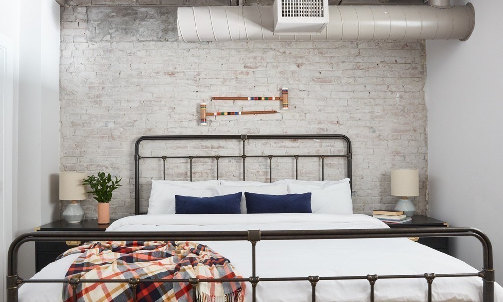 630 Washington Street, Unit 405 Boston, MA 02111 - Photo 6 of 10 a bedroom with a bed and a potted plant on dresser