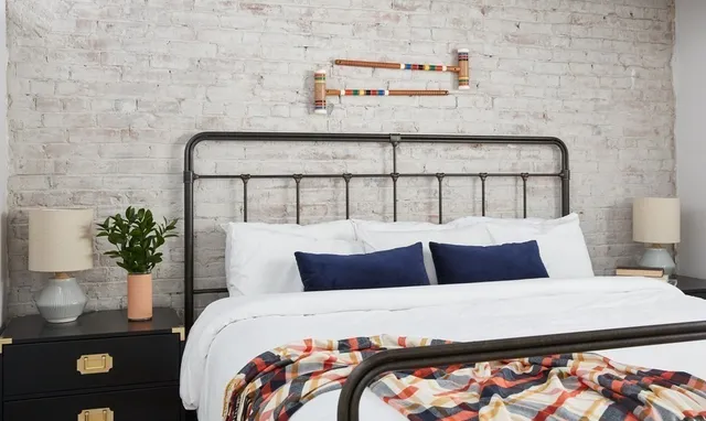 a bedroom with a bed and a potted plant