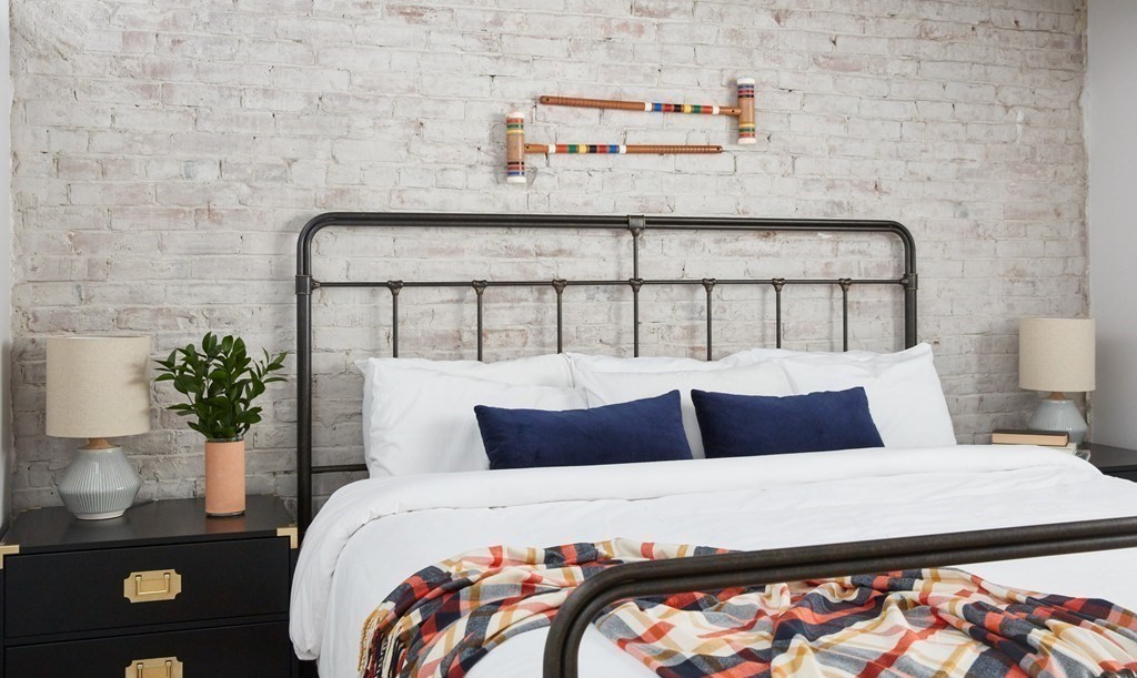 630 Washington Street, Unit 405 Boston, MA 02111 - Photo 7 of 10 a bedroom with a bed and a potted plant