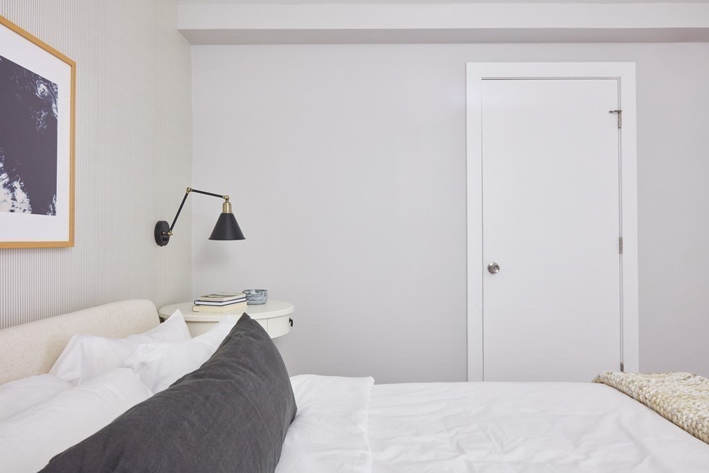 630 Washington Street, Unit 405 Boston, MA 02111 - Photo 10 of 10 a bedroom with a bed and a window