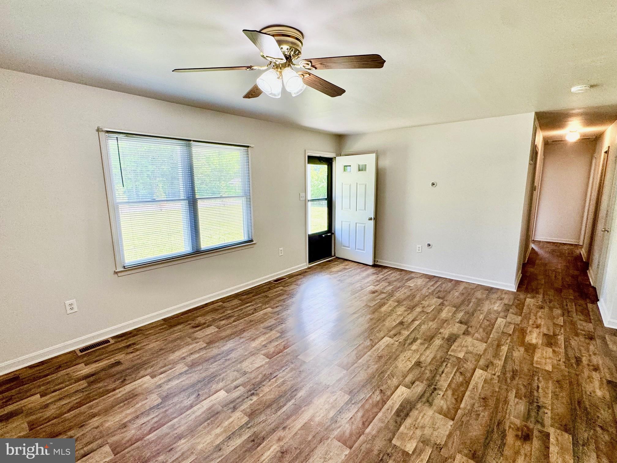 5207 Sumerduck Road Sumerduck, VA 22742 - Photo 5 of 18 a view of an empty room with window and wooden floor