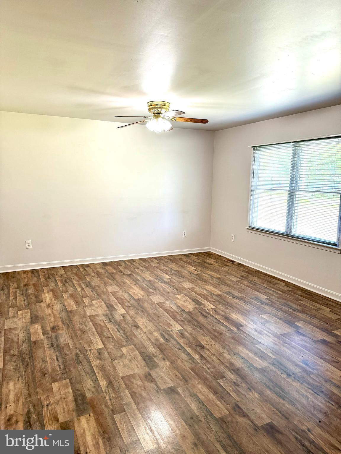 5207 Sumerduck Road Sumerduck, VA 22742 - Photo 6 of 18 an empty room with wooden floor and windows