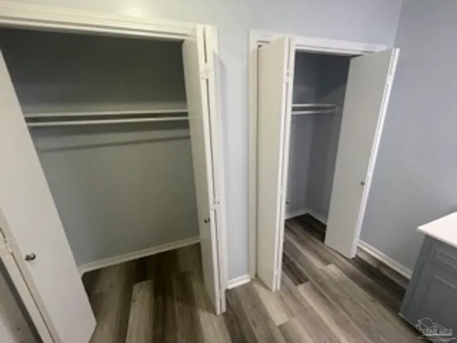 a view of walk in closet with wooden floor