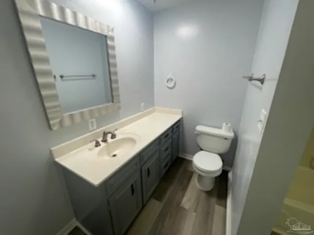 a bathroom with a sink toilet and mirror