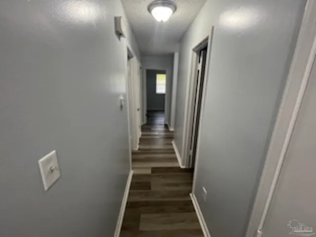 a view of a hallway with wooden floor and entryway