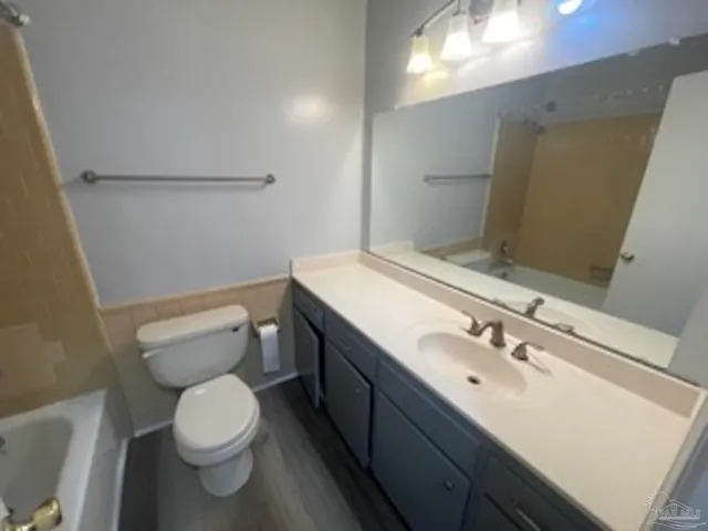 a bathroom with a sink a toilet and mirror