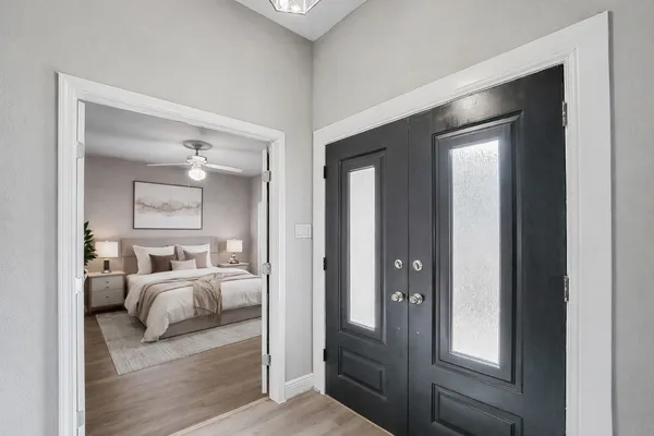 a bedroom with furniture and a mirror