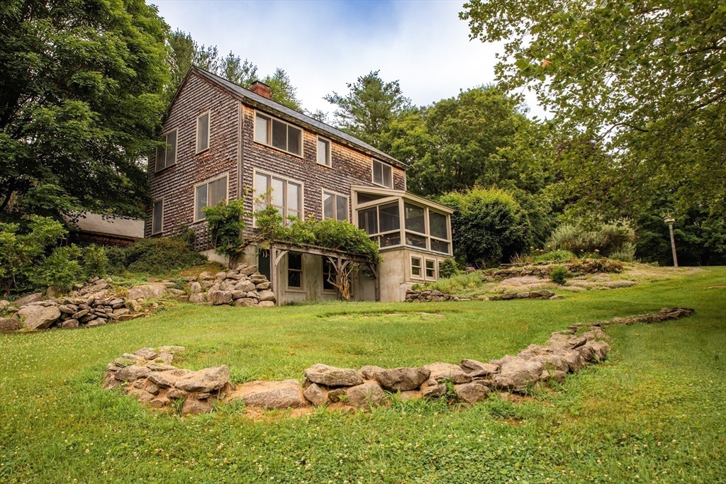 45 Sessions Road Hardwick, MA 01037 - Photo 25 of 28 a front view of a house with a yard swimming pool and outdoor seating