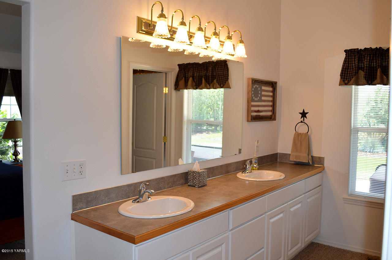 8104 Rutherford Road Yakima, WA 98903 - Photo 16 of 42 a bathroom with a sink double vanity and a mirror