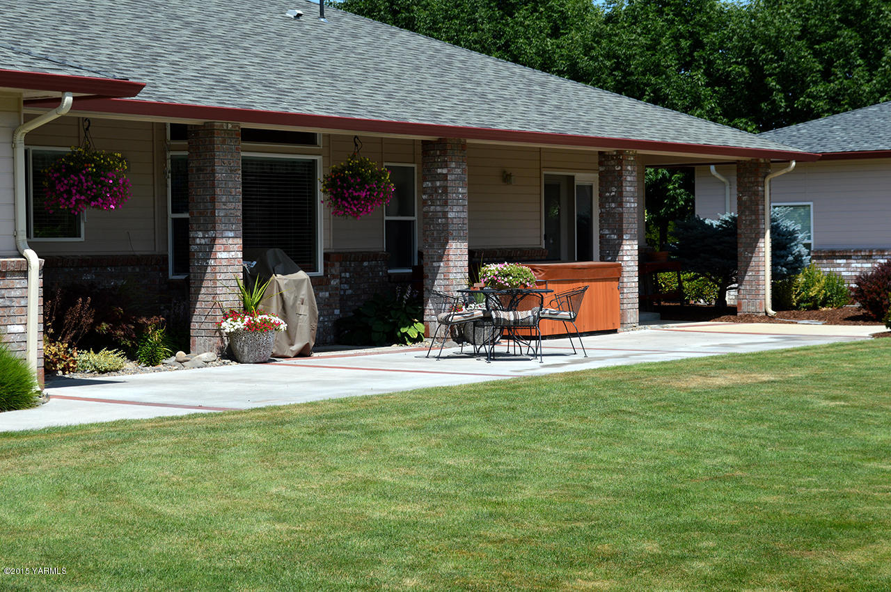 8104 Rutherford Road Yakima, WA 98903 - Photo 27 of 42 a view of a house with floor to ceiling windows and a basket ball poll