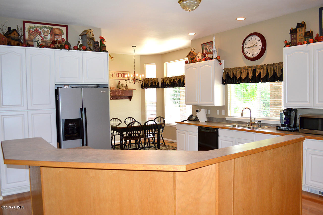 8104 Rutherford Road Yakima, WA 98903 - Photo 5 of 42 a kitchen with stainless steel appliances granite countertop a refrigerator and a stove top oven